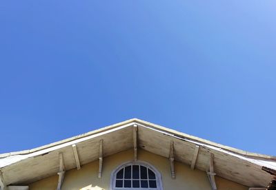 Low angle view of building against clear blue sky