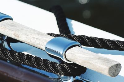 Close-up of rope tied to cleat of boat