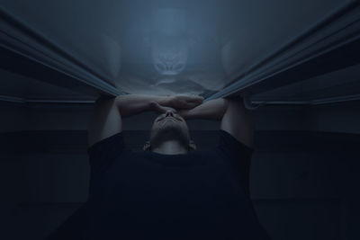 Low section of woman standing in darkroom