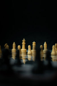 Close-up of chess pieces against black background