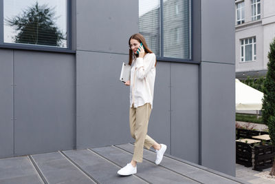 Young stylish white woman talking on a smartphone