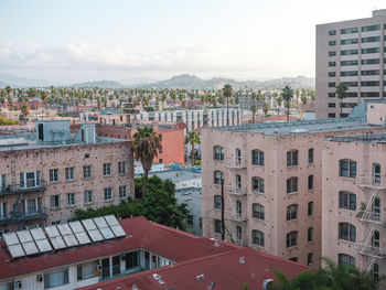 High angle view of buildings in town against sky