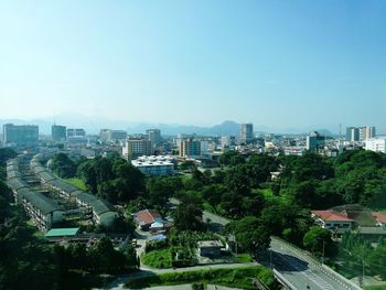 High angle view of cityscape against clear blue sky