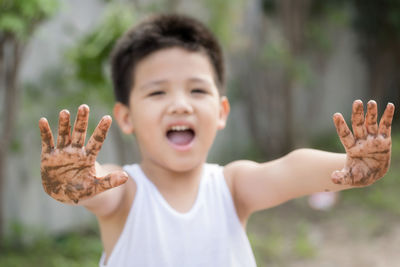 Portrait of cute boy smiling in park