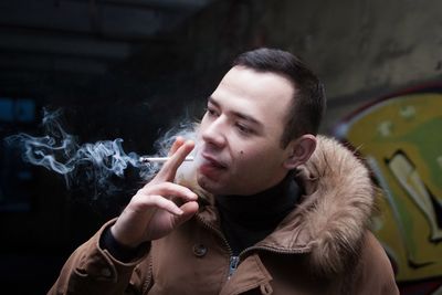 Close-up of young man smoking cigarette