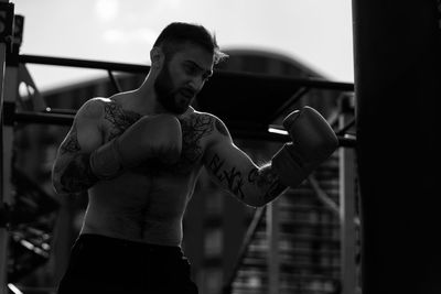 Man in boxing gloves is practicing on an outdoor