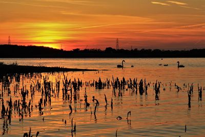 Scenic view of lake against sky during sunset