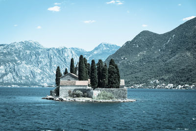 Scenic view of sea and mountains against sky