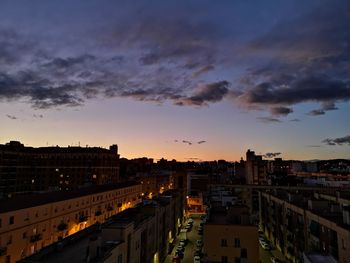 High angle view of illuminated buildings against sky at sunset