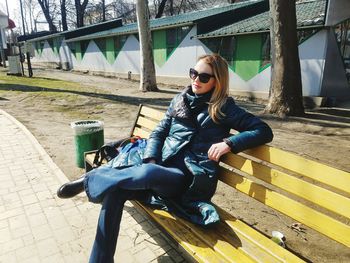 Young woman sitting on bench