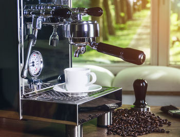 Close-up of coffee cups on table at home
