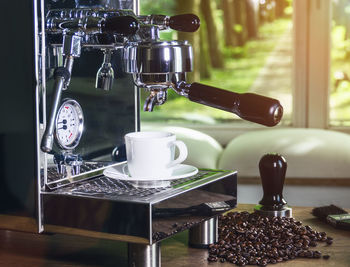 Close-up of espresso maker on table at cafe