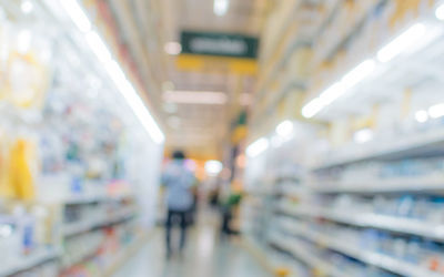 Blurred motion of people walking in illuminated store