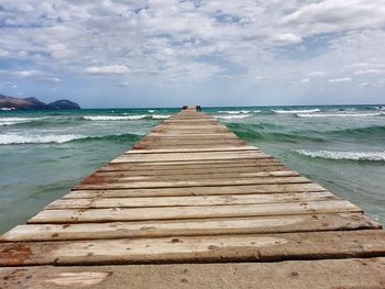 Pier over sea against sky