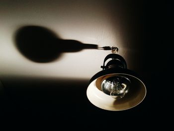 Low angle view of pendant light hanging from ceiling at home