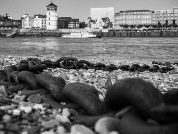 Surface level of sea against sky in city