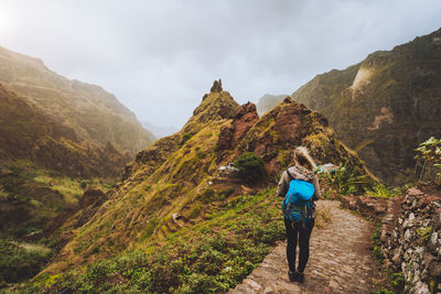 Rear view of man walking on mountain