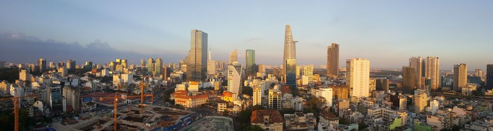 Panoramic shot of modern buildings in city against sky