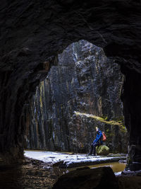 Rear view of man standing in cave