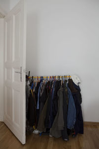 Clothes hanging over hardwood floor at home