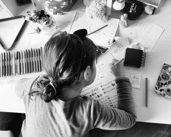 High angle view portrait of boy on table