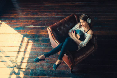 Young woman sitting on staircase