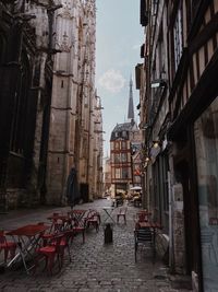 Empty alley amidst buildings in city