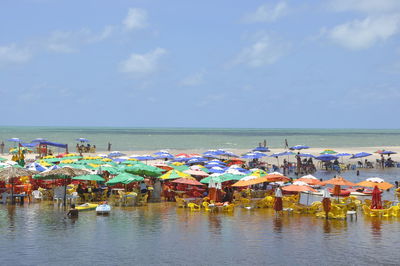 Boats on beach by sea against sky