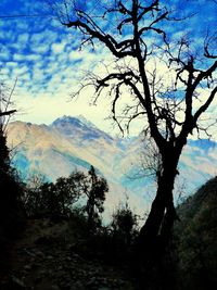 Scenic view of mountains against cloudy sky