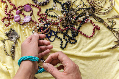 Cropped hands of woman wearing bracelet indoors