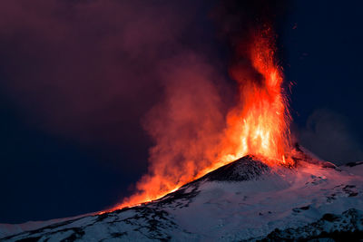 View of illuminated bonfire against sky during winter