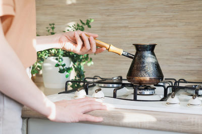 Cropped hands of man preparing food on table