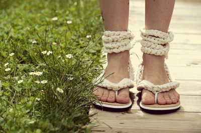 Low section of woman standing on grass