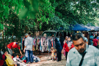 Rear view of people walking in market