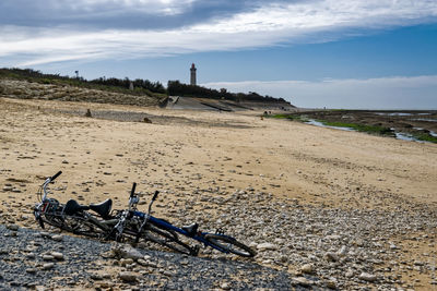 Lighthouse at beach in saint-clement-des-baleines against sky