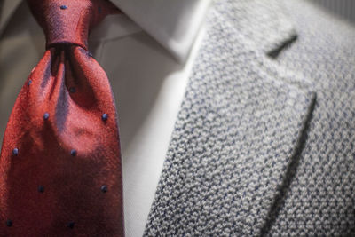 Midsection of man wearing suit and necktie