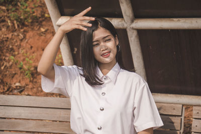 Portrait of smiling young woman standing outdoors