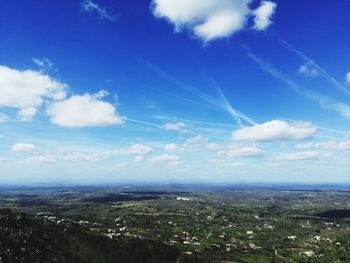 Aerial view of landscape against blue sky