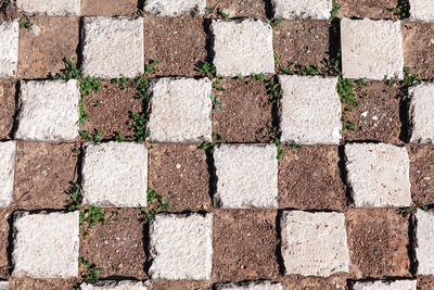 Pavement in squares . cobblestones and ground . symmetrical shape figures surface