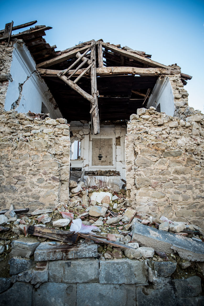 LOW ANGLE VIEW OF OLD ABANDONED BUILDING AGAINST SKY