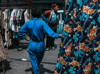 Men standing at market stall