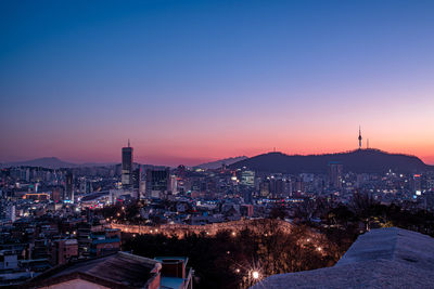 High angle view of illuminated buildings against sky at night