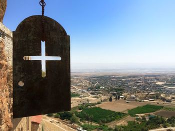 Clock tower amidst buildings in city against clear sky