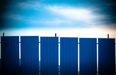 Low angle view of factory against blue sky