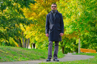 Portrait of man standing in park