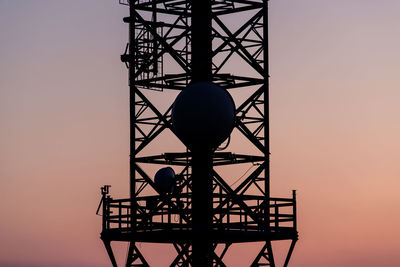 Low angle view of silhouette tower against sky during sunset