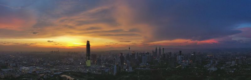 Scenic view of buildings against sky during sunset