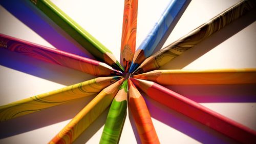 Low angle view of multi colored pencils on table