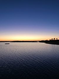 Scenic view of sea against clear sky during sunset