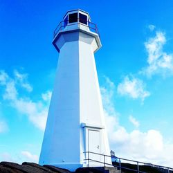 Low angle view of lighthouse against blue sky